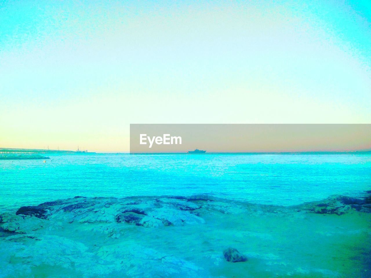 SCENIC VIEW OF BEACH AGAINST CLEAR BLUE SKY