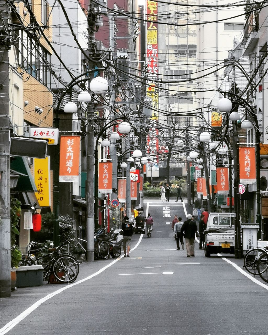 PEOPLE RIDING BICYCLE ON ROAD