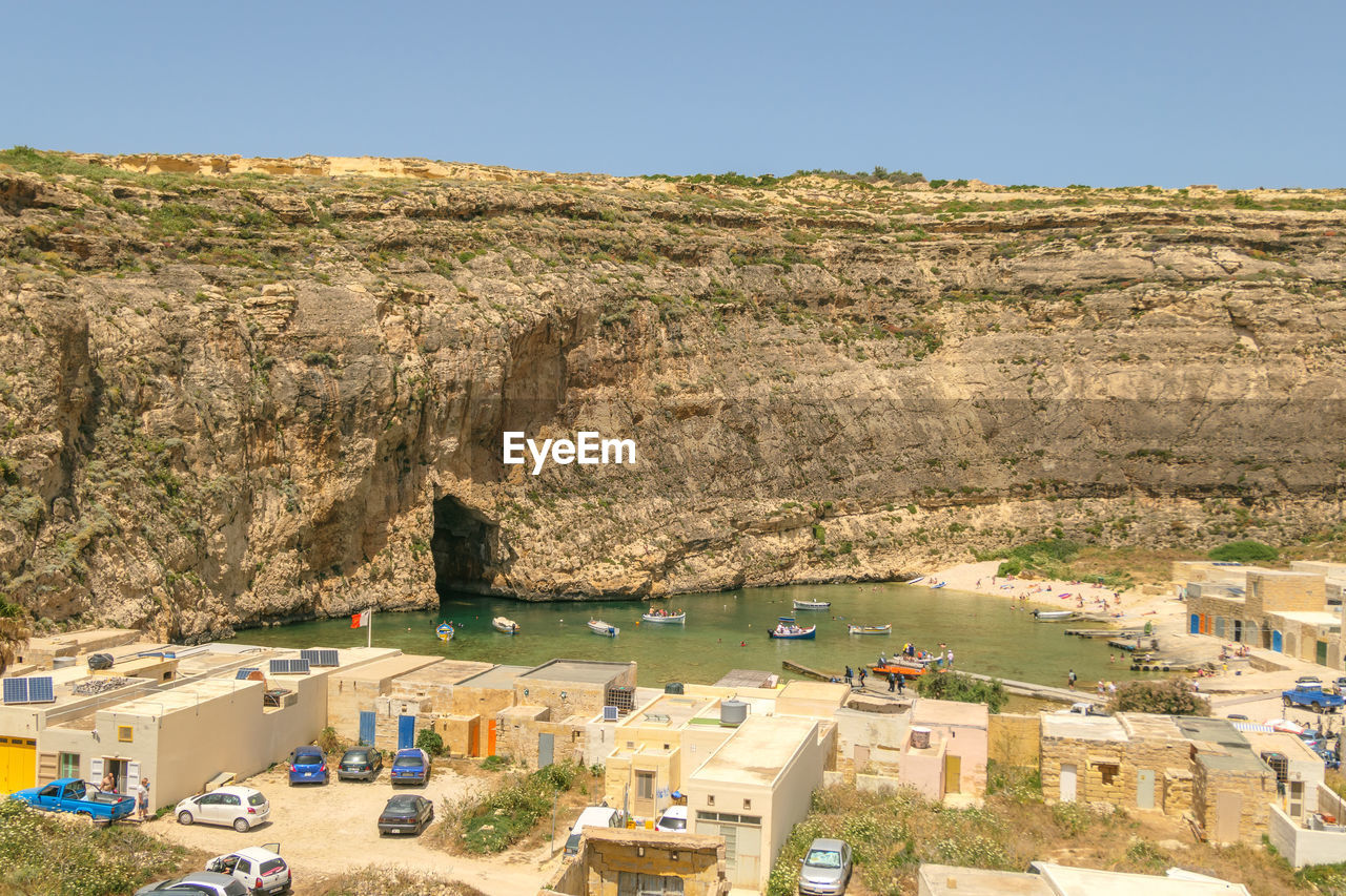 Panoramic view of land and mountains against clear sky