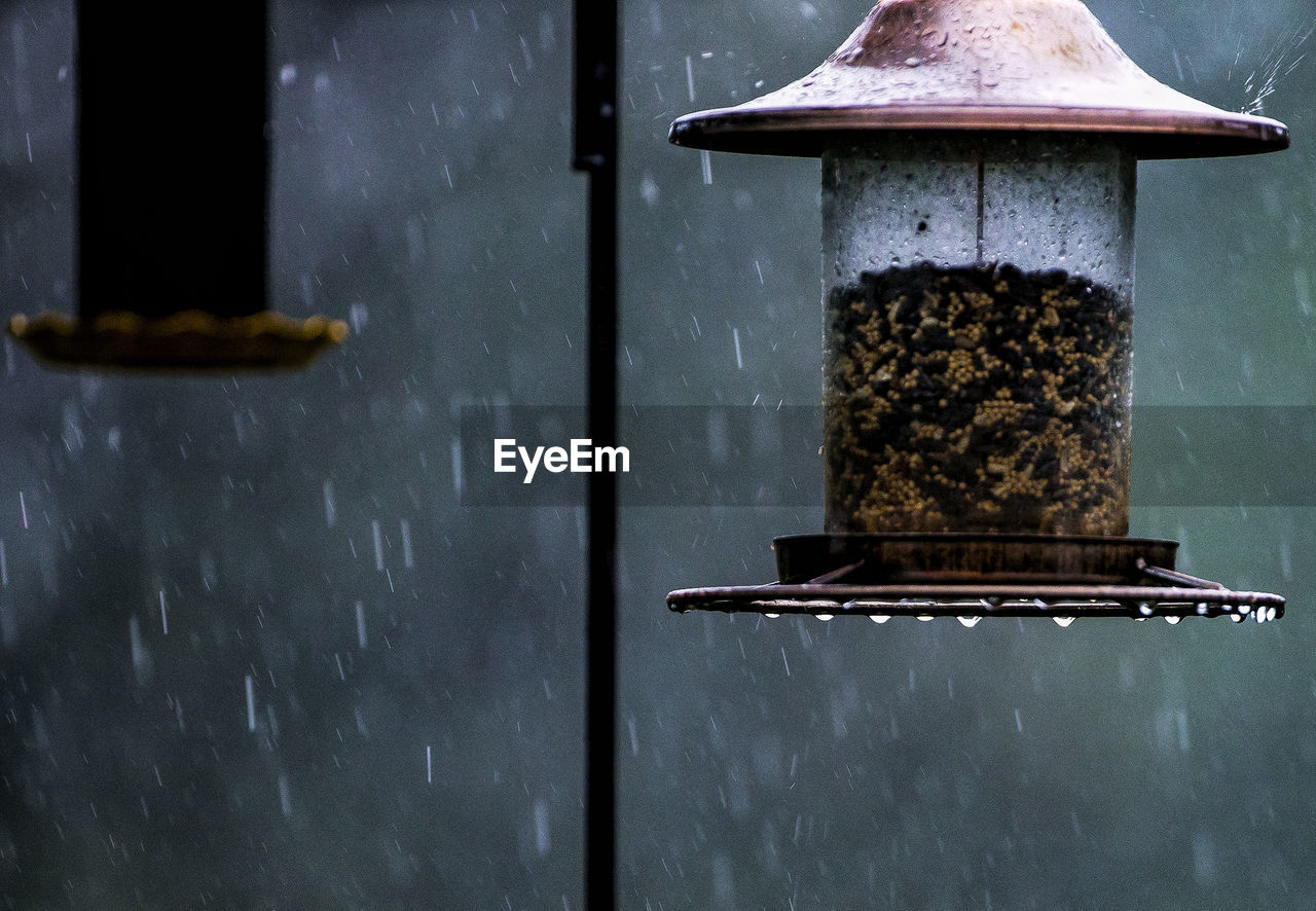Close-up of bird feeder during rainy season