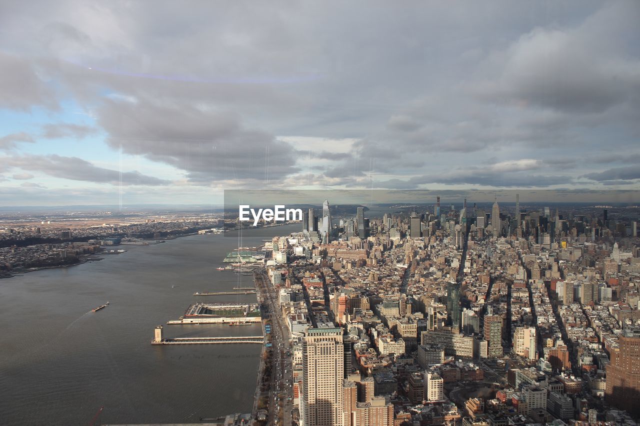 High angle view of city against cloudy sky