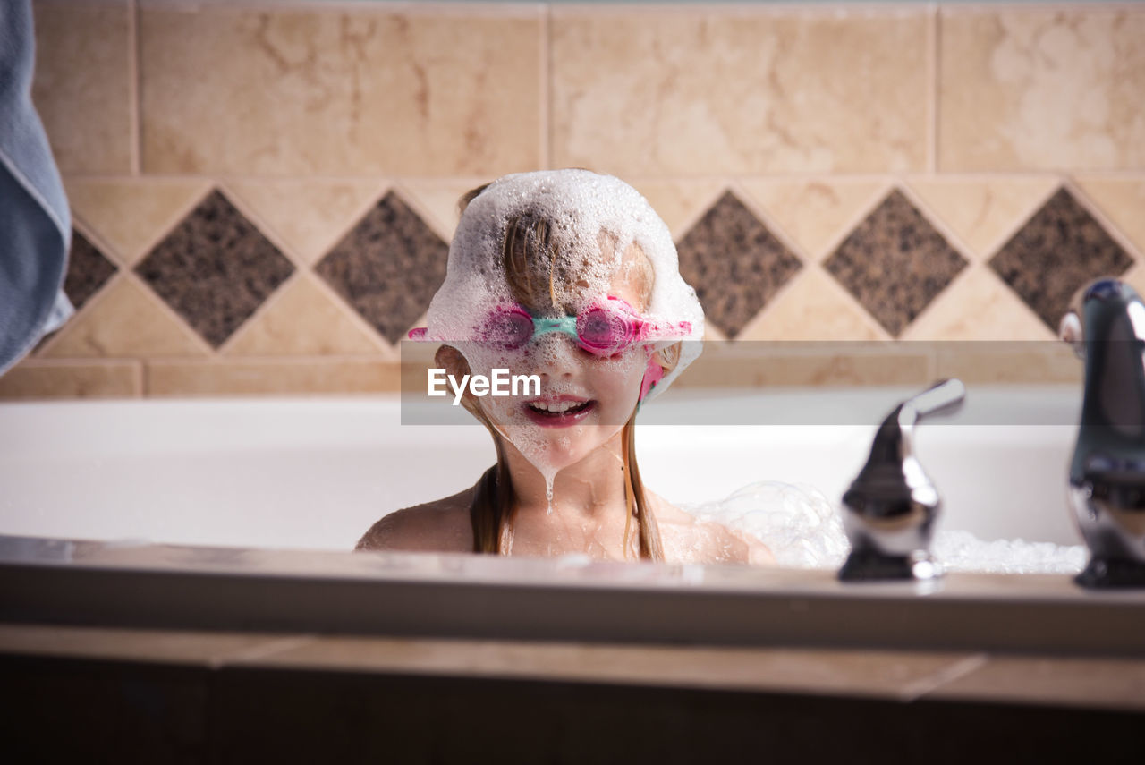 Close-up of girl in bathtub