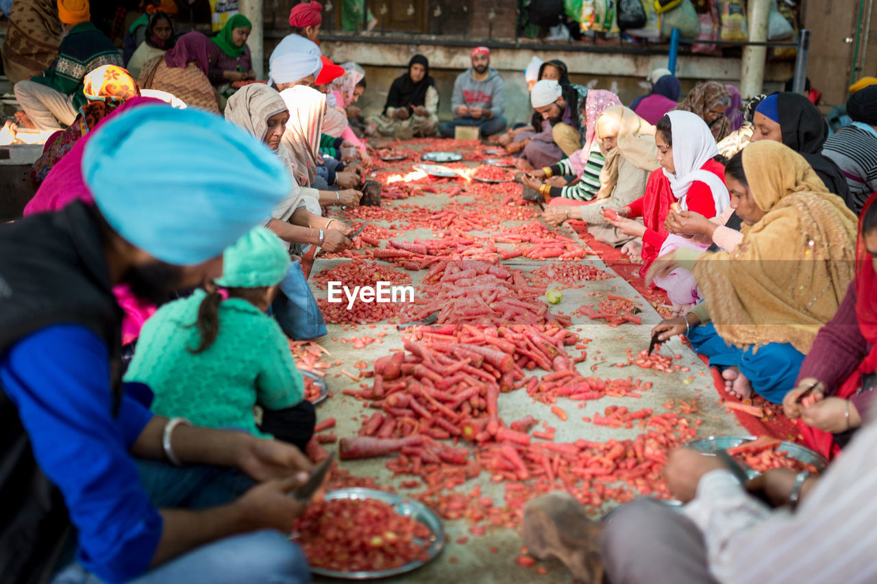 PEOPLE IN MARKET STALL