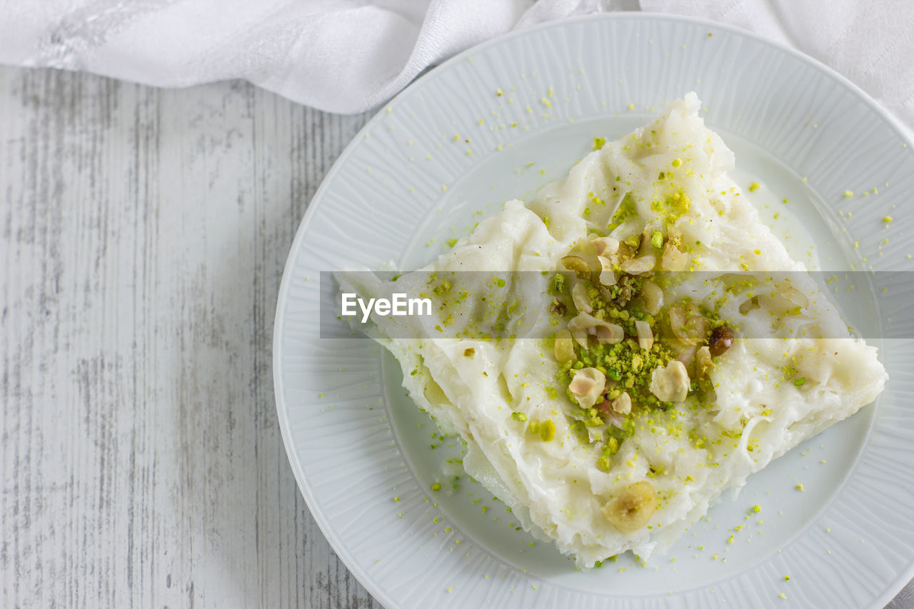 Traditional turkish meal - gullac. milk dessert sprinkled with ground nuts and pistachios. ramadan 