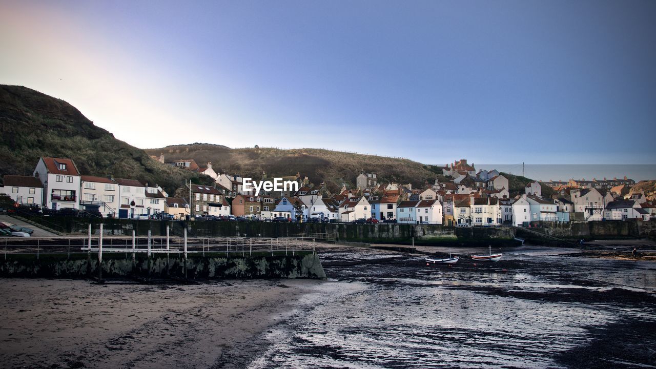 HOUSES IN TOWN AGAINST CLEAR SKY