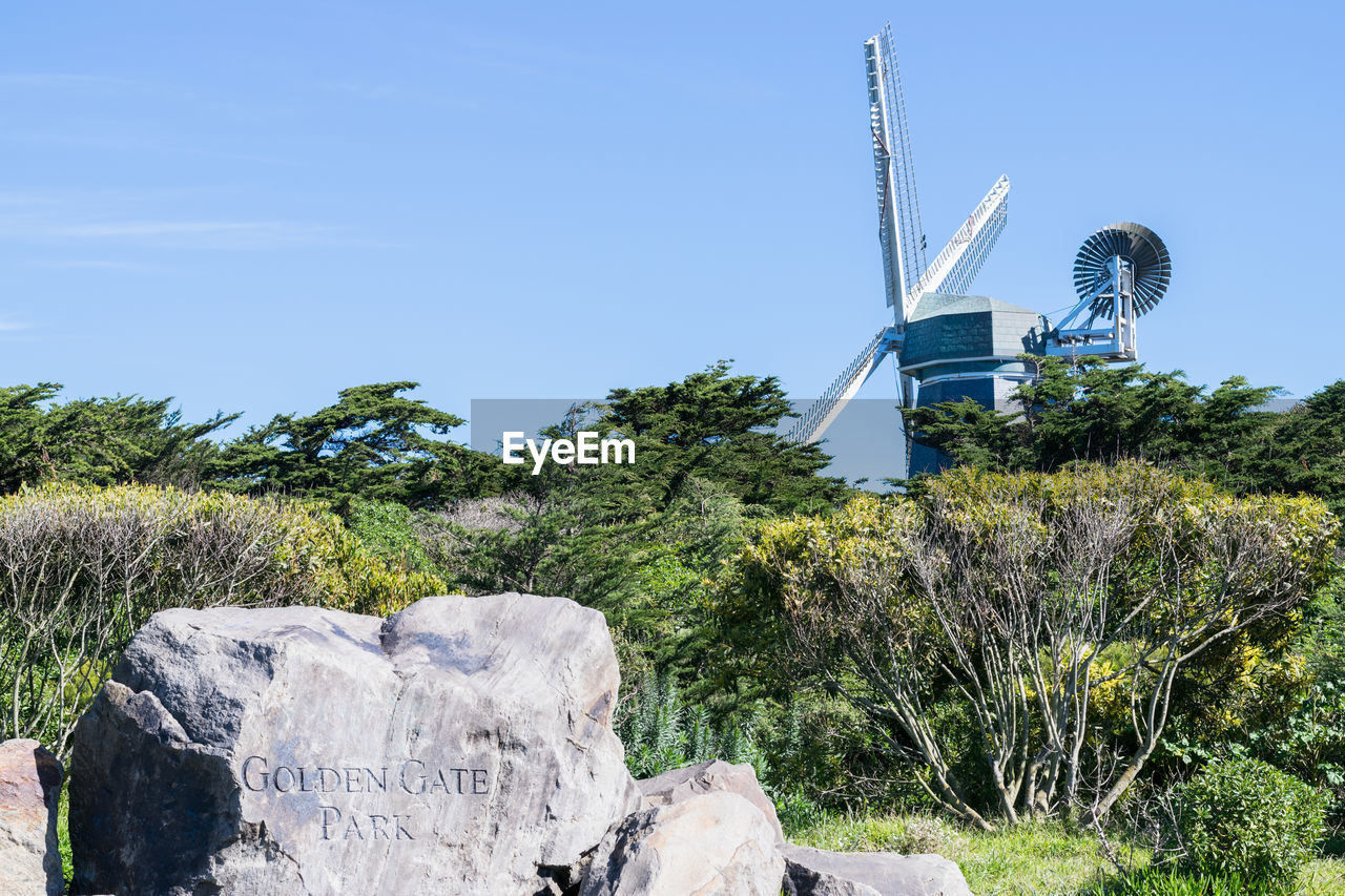 LOW ANGLE VIEW OF WIND TURBINES ON LAND