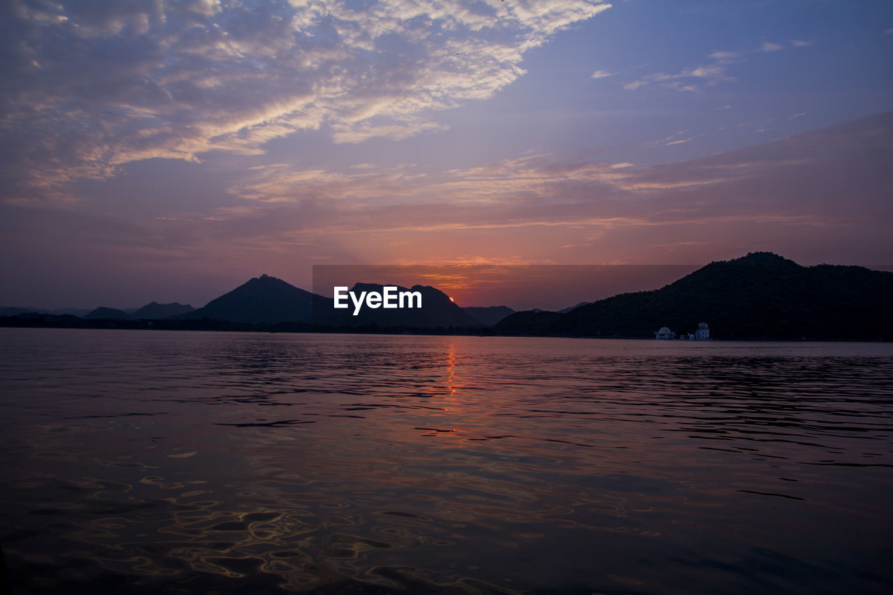 sky, water, mountain, scenics - nature, horizon, beauty in nature, sunset, reflection, cloud, sea, nature, dusk, tranquility, land, evening, tranquil scene, travel destinations, landscape, environment, no people, afterglow, sunlight, travel, ocean, outdoors, beach, mountain range, bay, silhouette, coast, body of water, dramatic sky, idyllic, sun, tourism