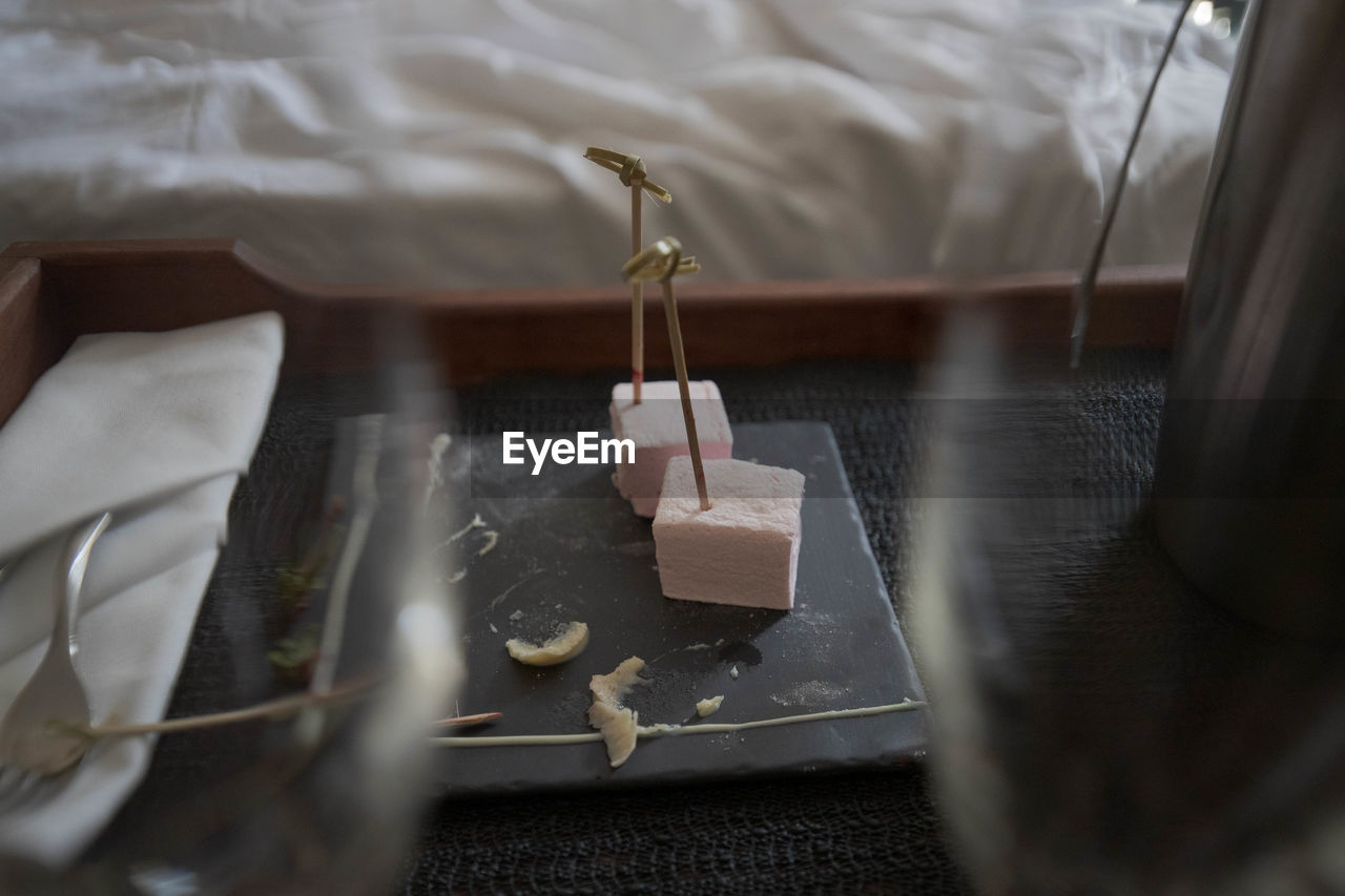 High angle view of desert on table between glasses