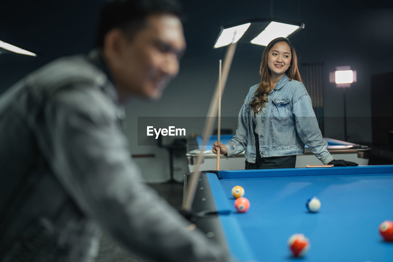 close-up of man playing pool