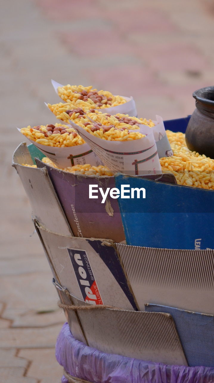 Close-up of puffed rice at concession stand on footpath