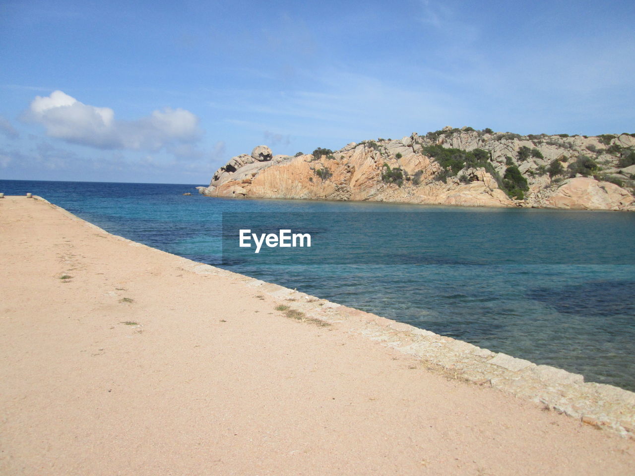 SCENIC VIEW OF BEACH AGAINST BLUE SKY