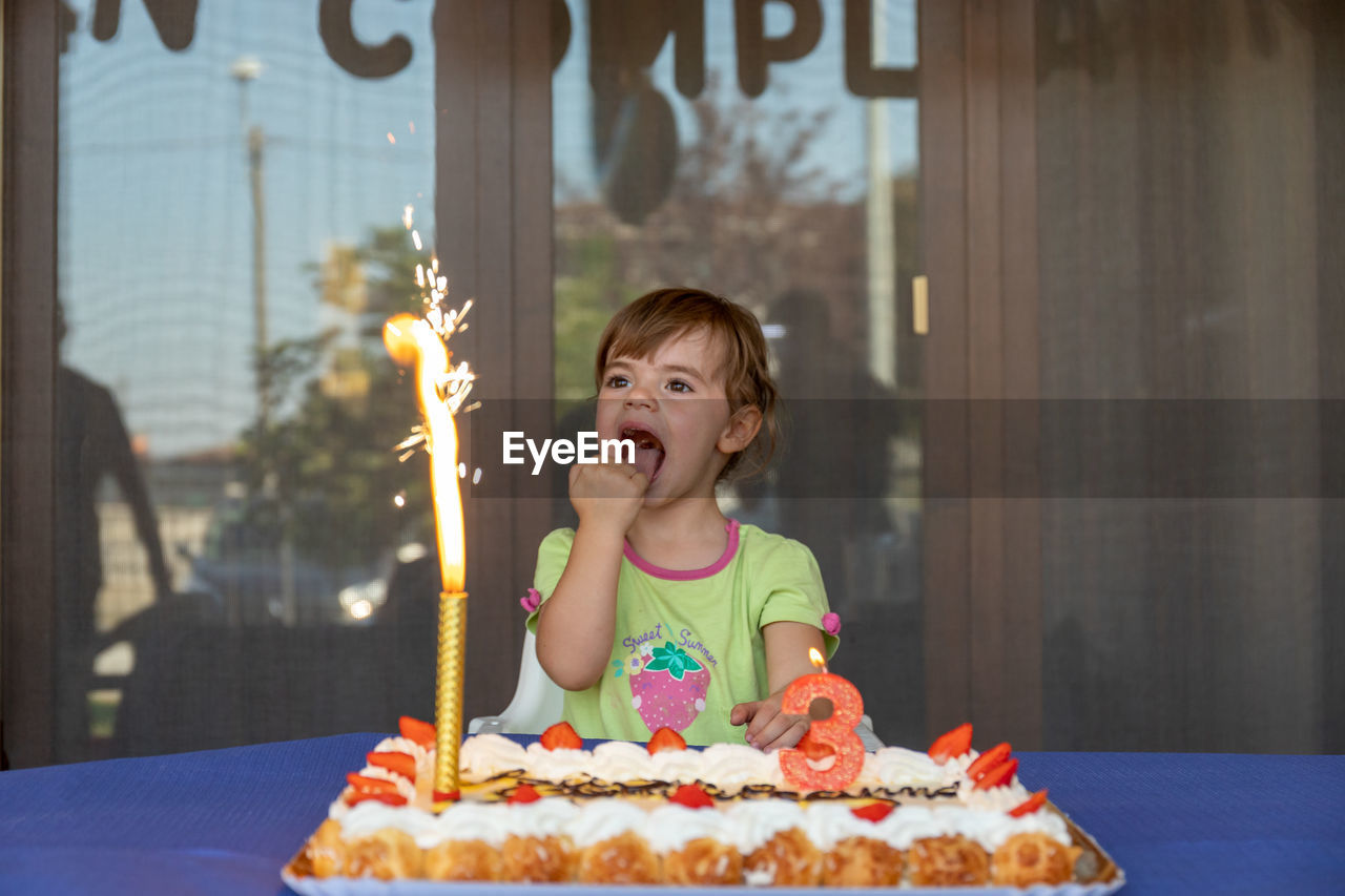 Portrait of smiling girl on cake