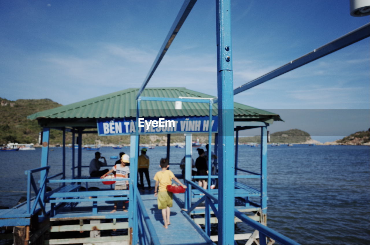 PEOPLE IN BOAT AGAINST SEA