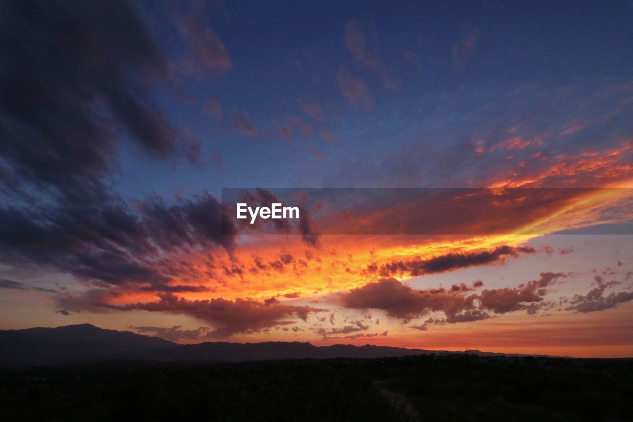 SCENIC VIEW OF DRAMATIC SKY OVER SILHOUETTE LAND