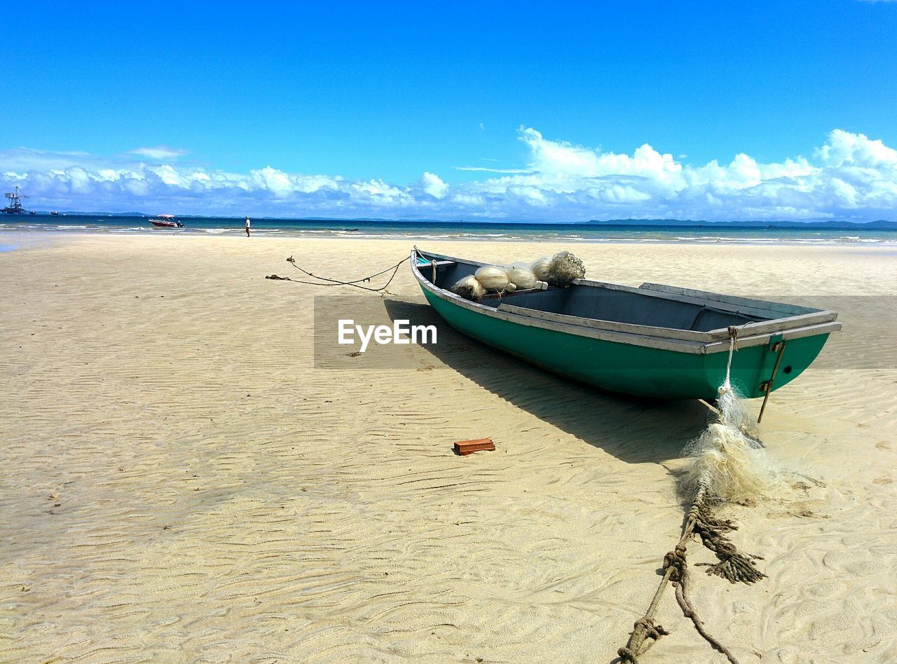 BOAT ON BEACH AGAINST SKY