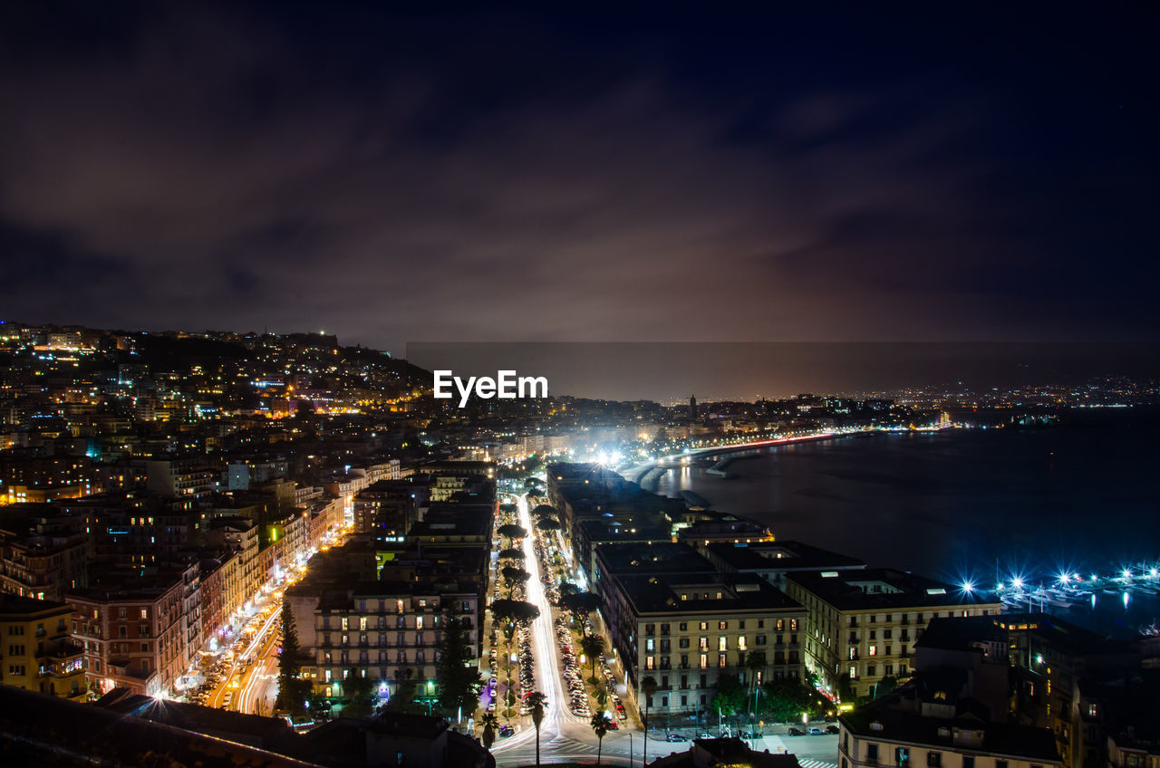 Illuminated cityscape against sky at night