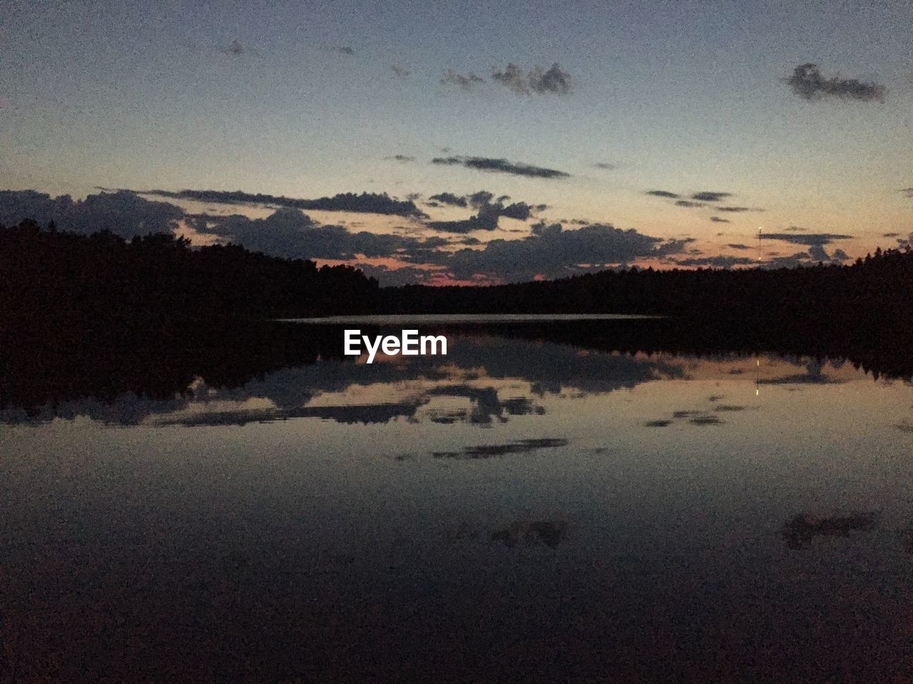 SCENIC VIEW OF LAKE BY SILHOUETTE TREES AGAINST SKY