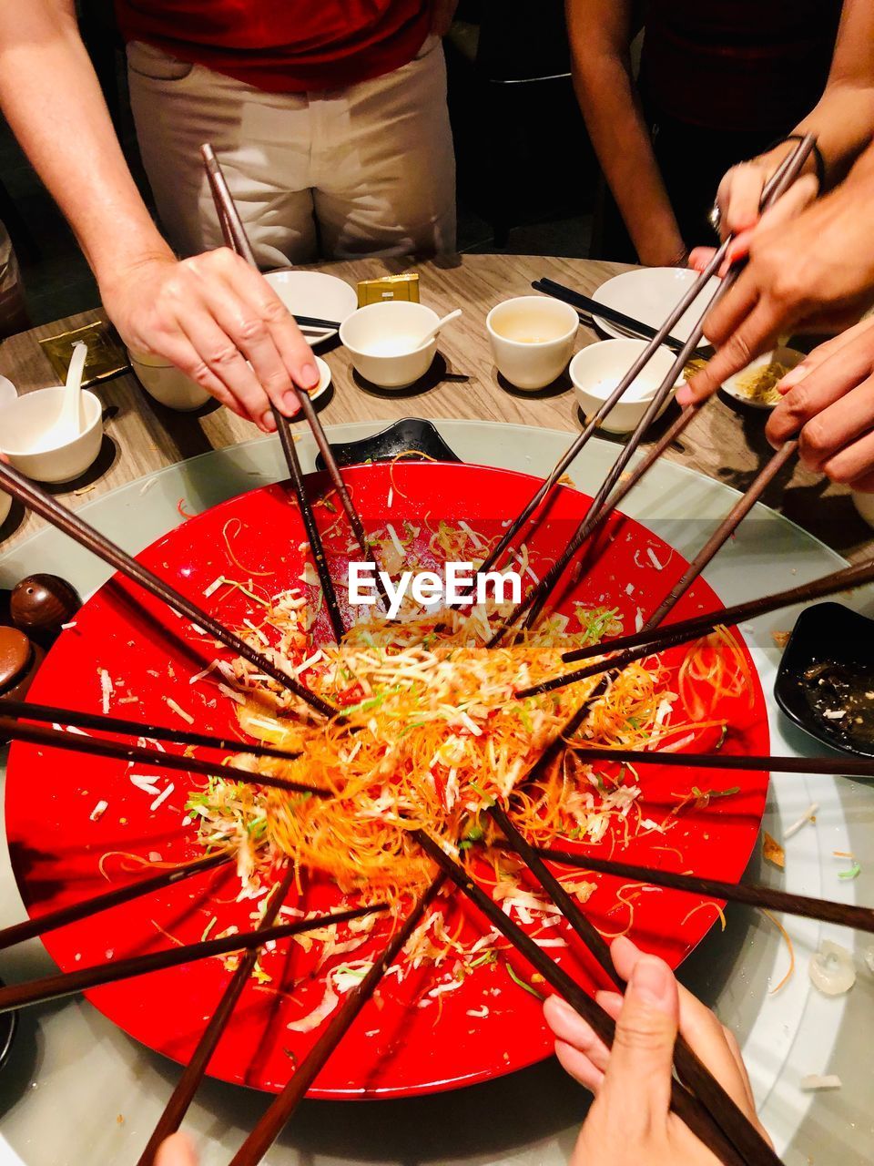 HIGH ANGLE VIEW OF PEOPLE HOLDING FOOD