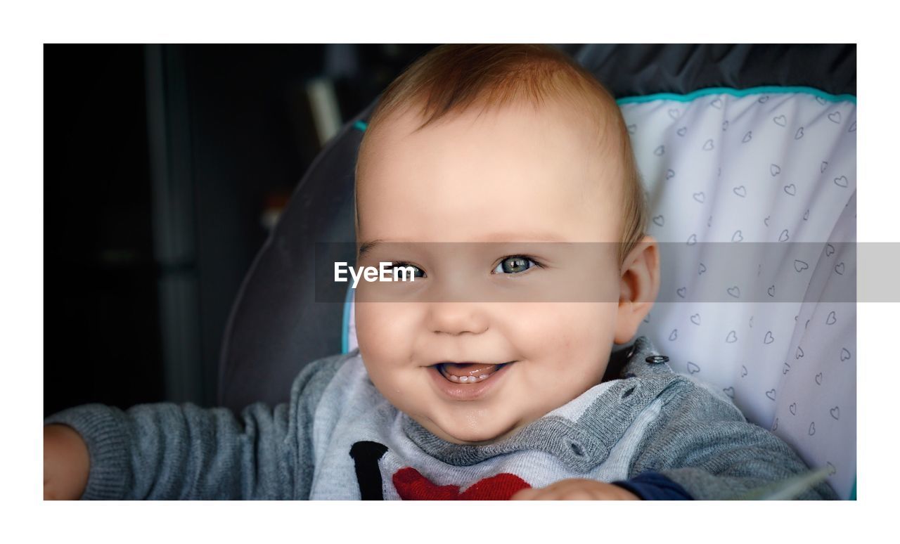 Close-up portrait of cute happy baby boy at home