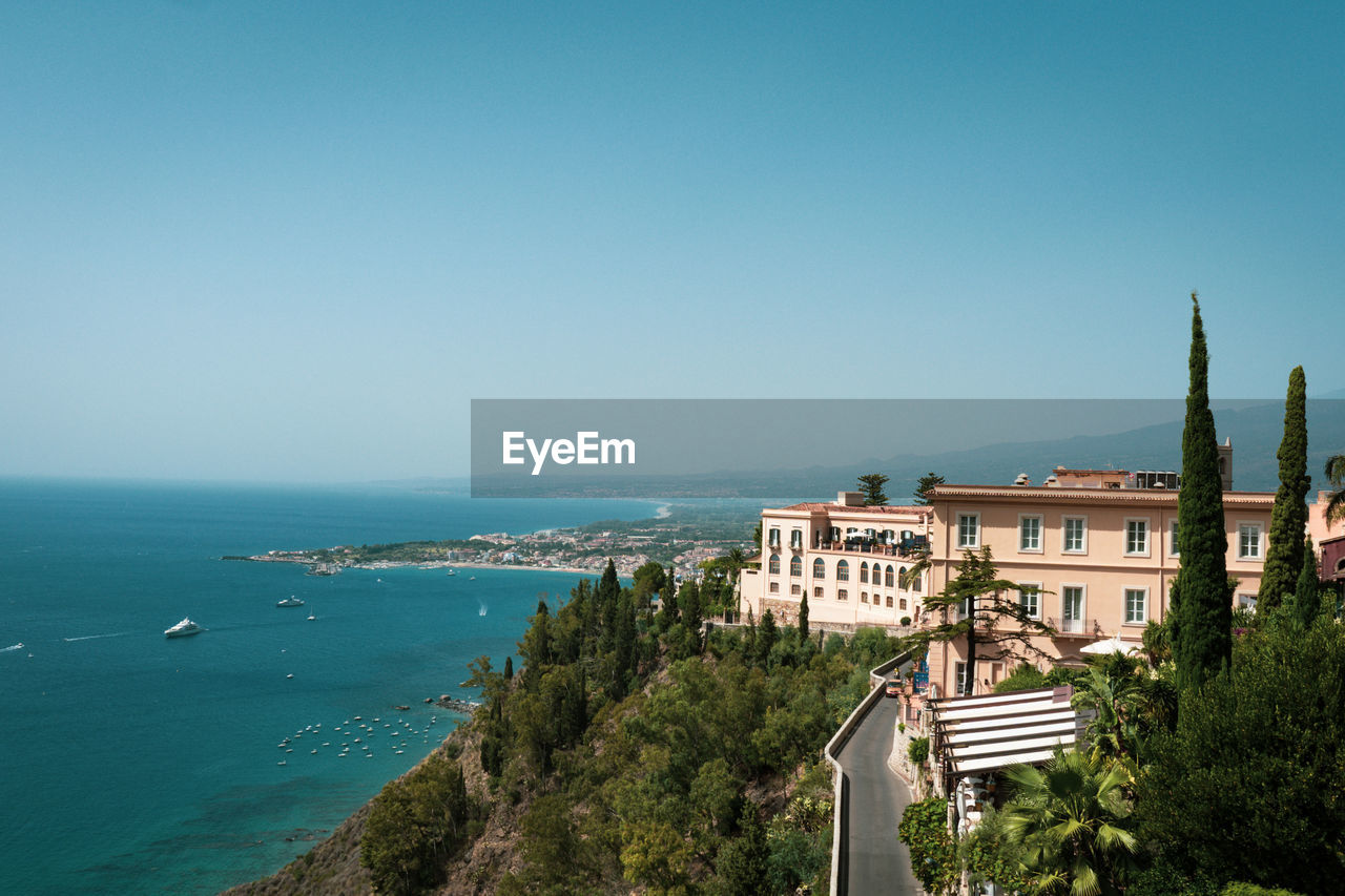 Hotel building in taormina with accommodation for tourists on a hill