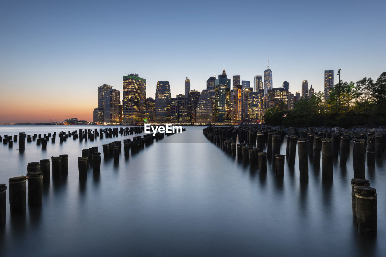 Panoramic view of river and buildings against clear sky