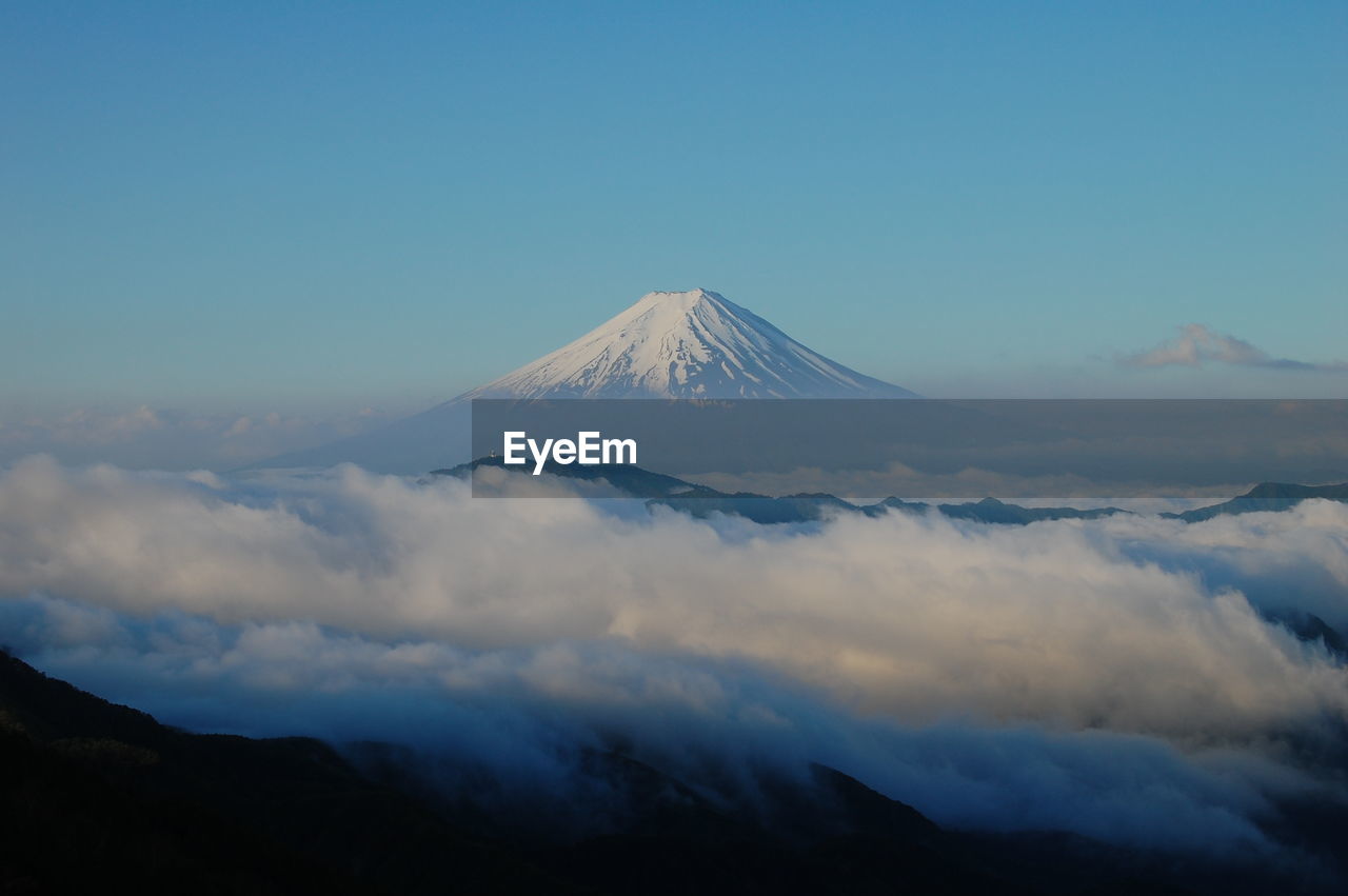View of volcanic mountain against blue sky
