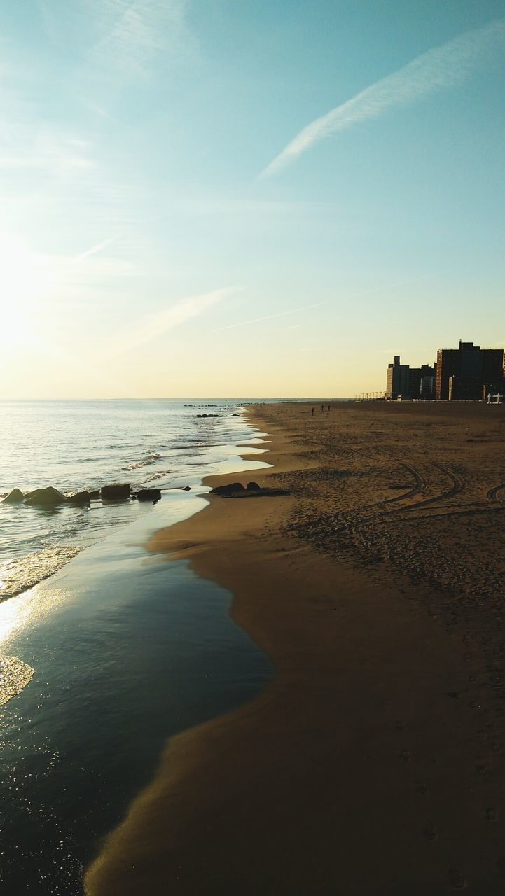 Scenic view of beach against sky during sunset