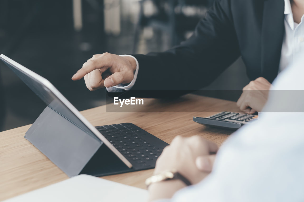 Businessmen using digital tablet in office