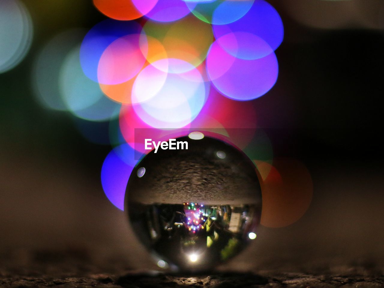 light, sphere, illuminated, macro photography, multi colored, blue, reflection, night, no people, lighting, decoration, shiny, celebration, circle, close-up, light - natural phenomenon, purple, liquid bubble, yellow, disco ball, shape, darkness, glowing, lighting equipment, nature, outdoors, geometric shape, crystal ball, focus on foreground