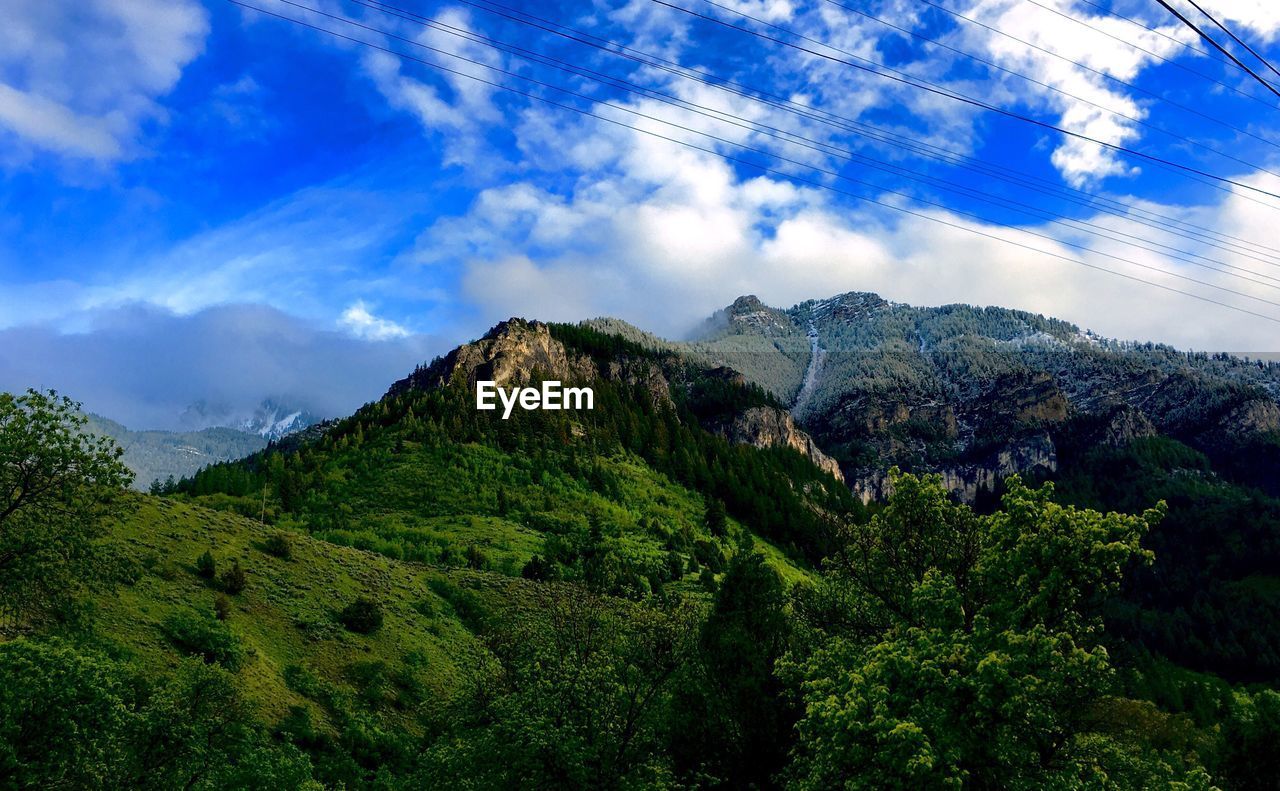 Scenic view of mountains against cloudy sky