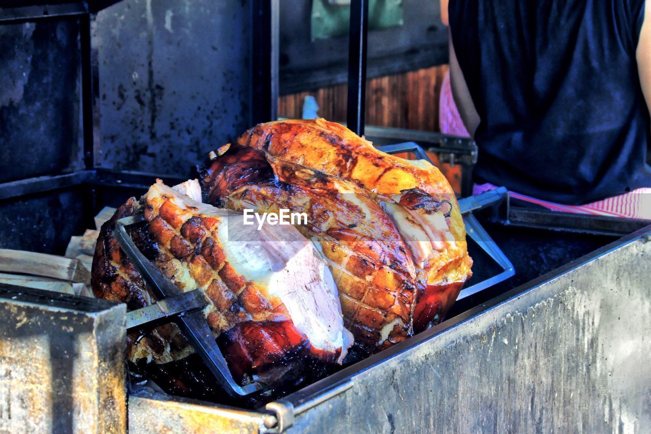 Close-up of rotisserie chicken on barbecue grill