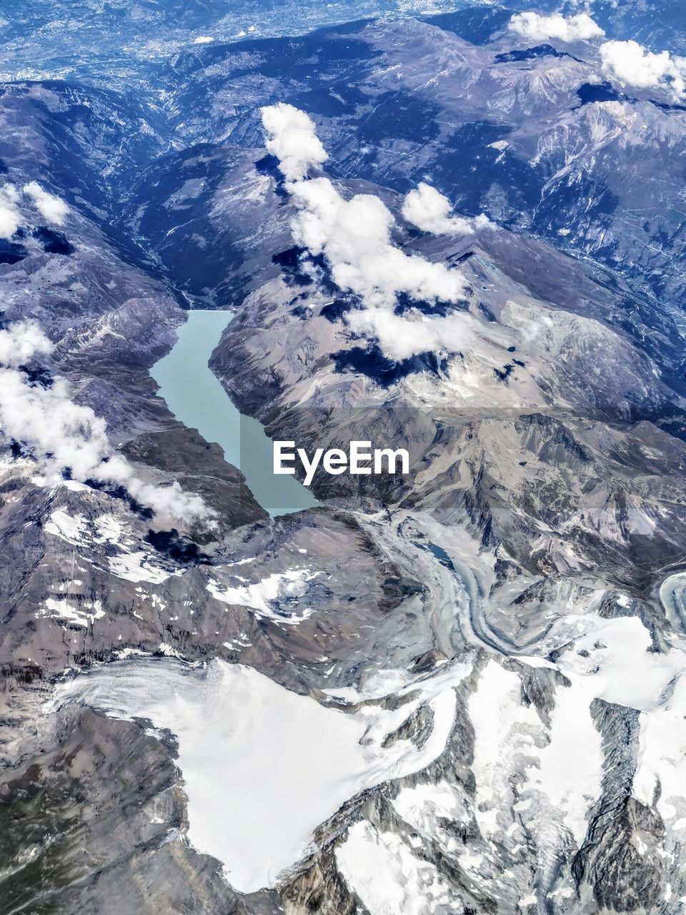 Aerial view of snowcapped mountains against sky