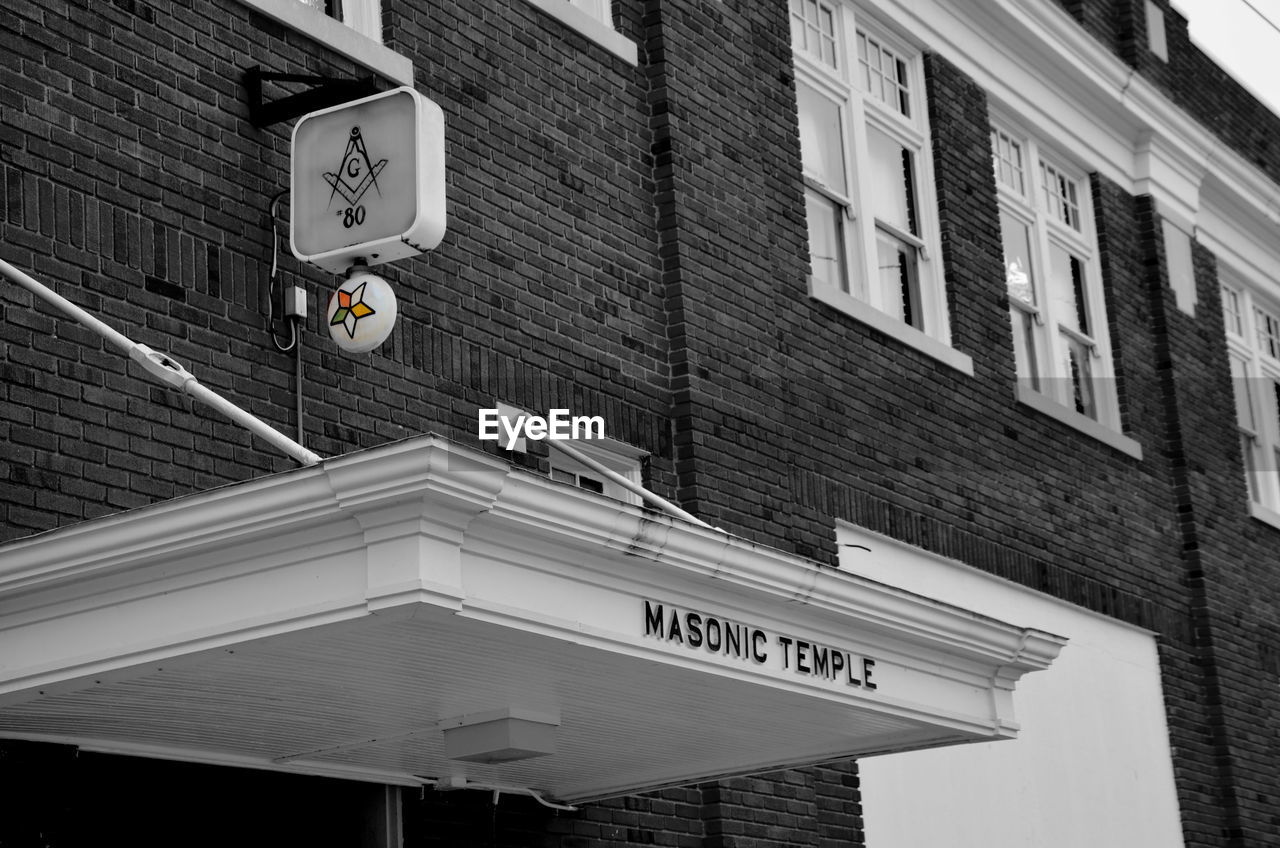 ROAD SIGN IN FRONT OF BUILDING