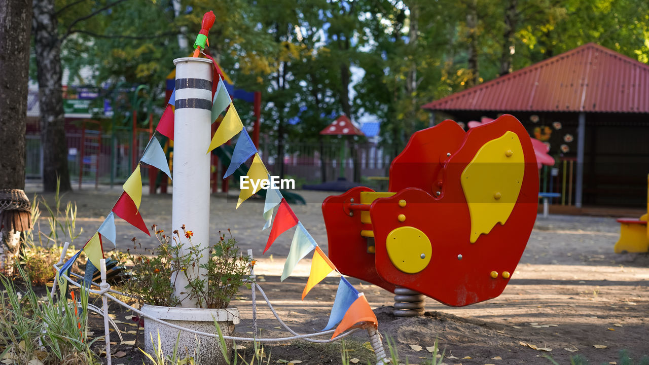 CLOSE-UP OF MULTI COLORED UMBRELLAS ON PARK