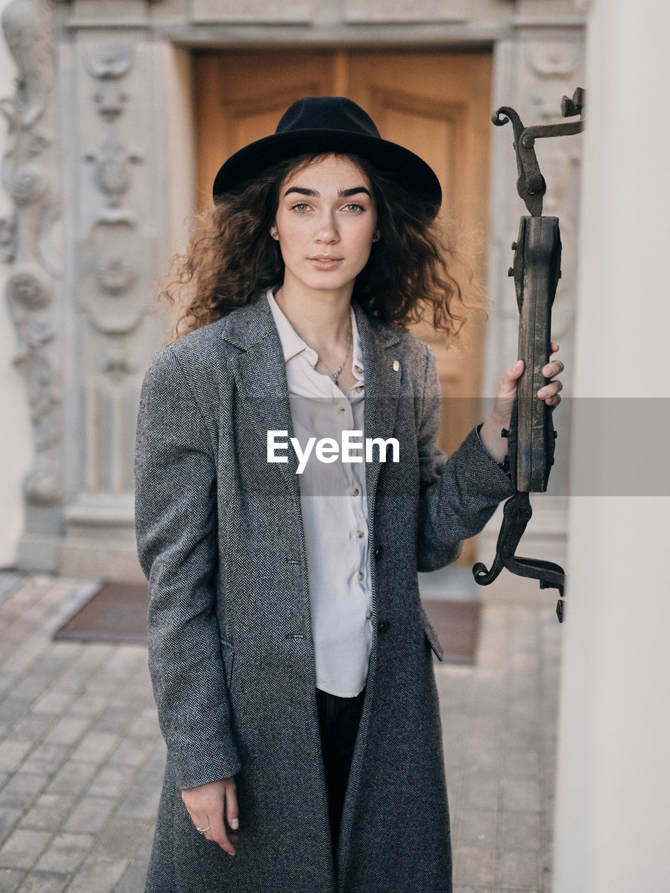 Portrait of woman standing at entrance