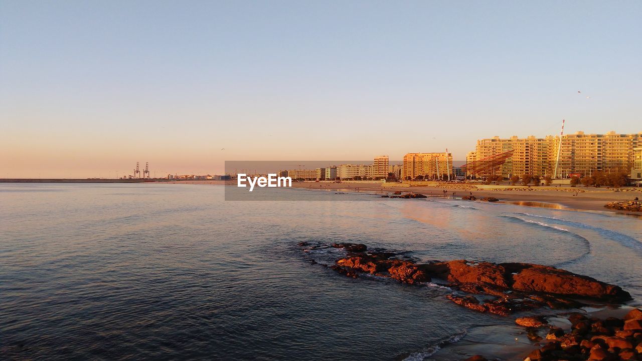 Scenic view of sea against clear sky during sunset