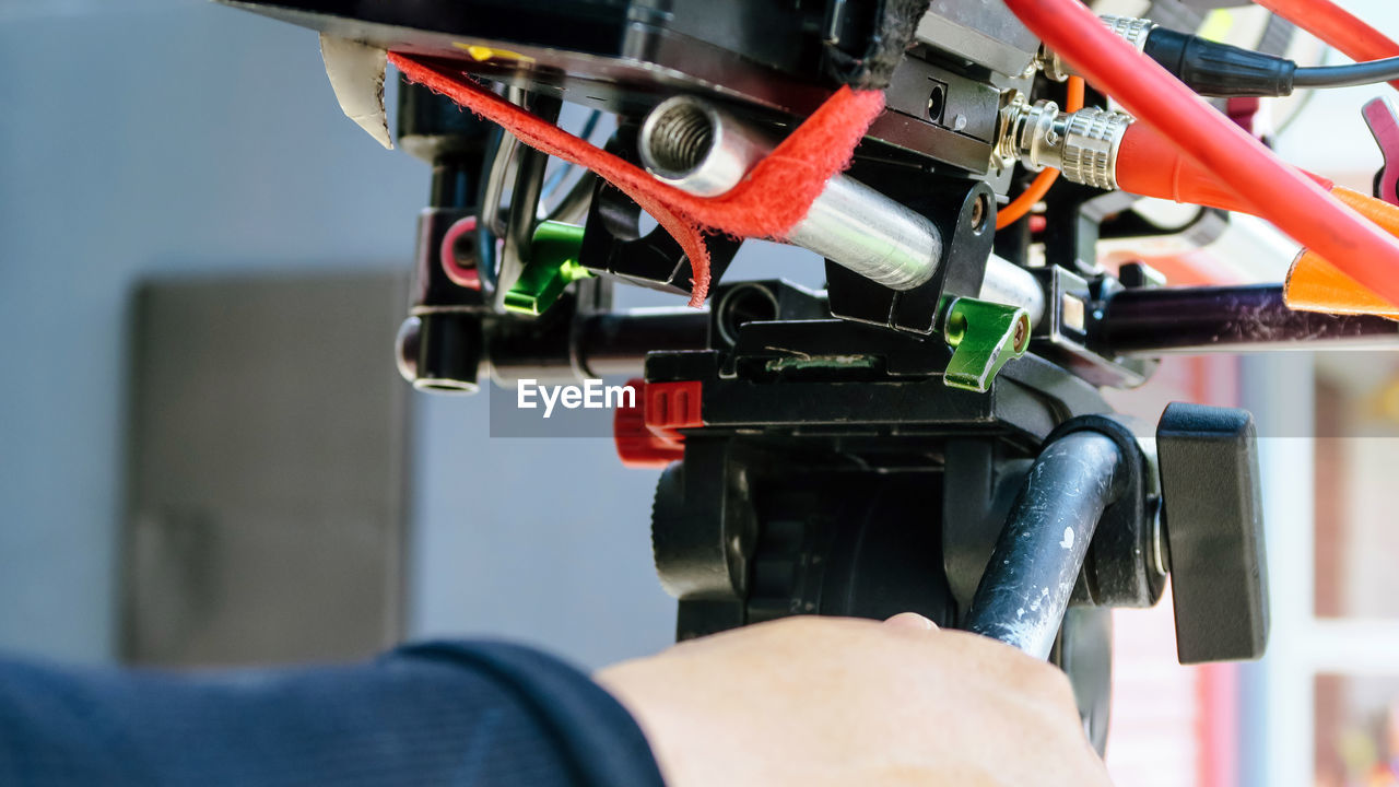 CLOSE-UP OF HAND USING MACHINE