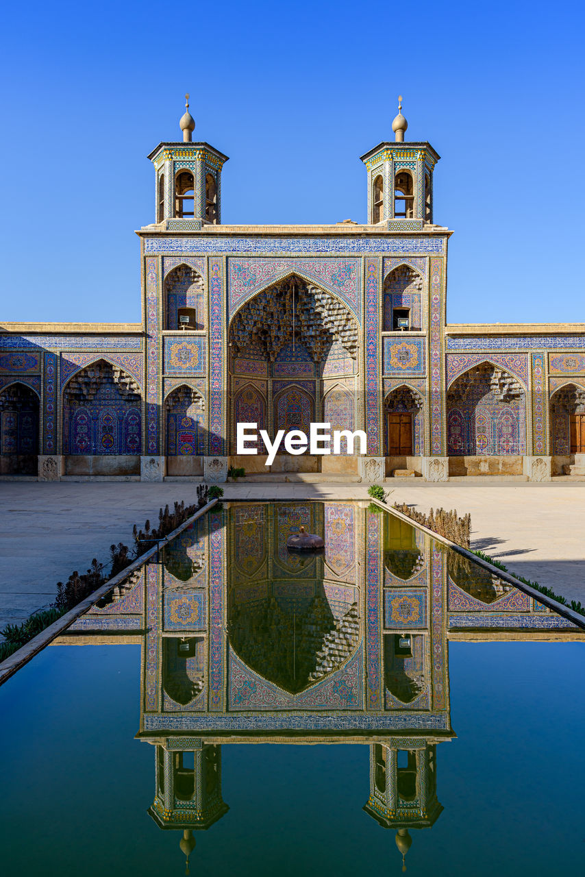 VIEW OF MOSQUE AGAINST BLUE SKY