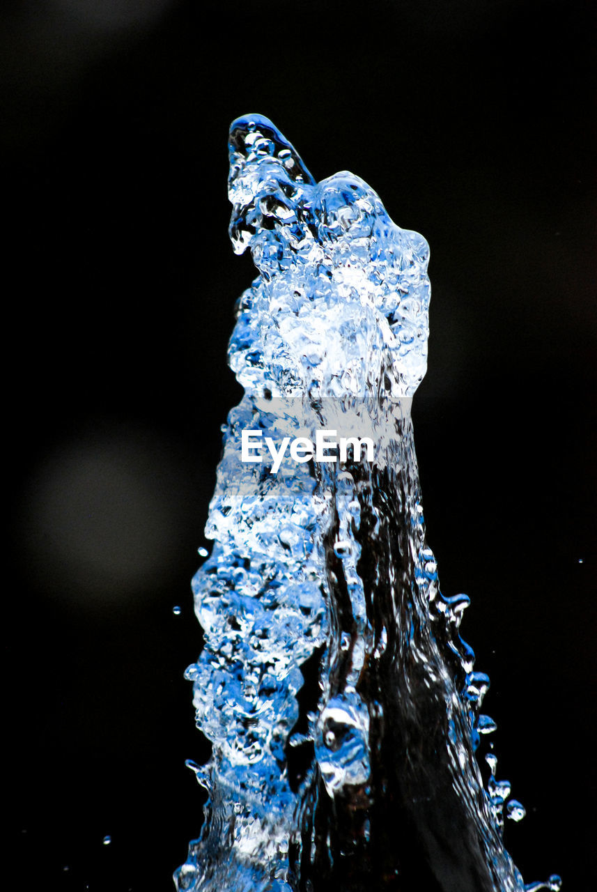 CLOSE-UP OF WATER DROP ON BLACK BACKGROUND