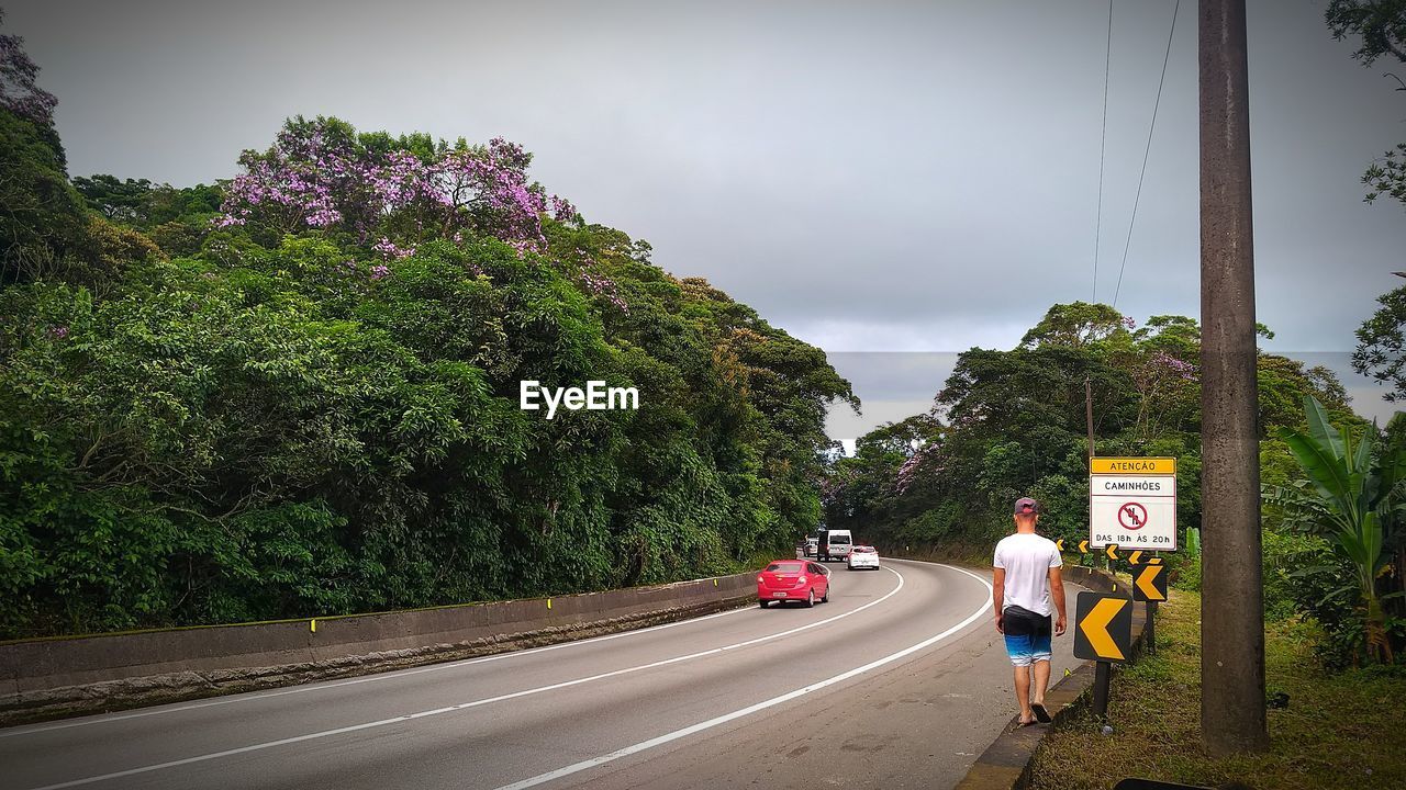 CARS ON ROAD AGAINST SKY