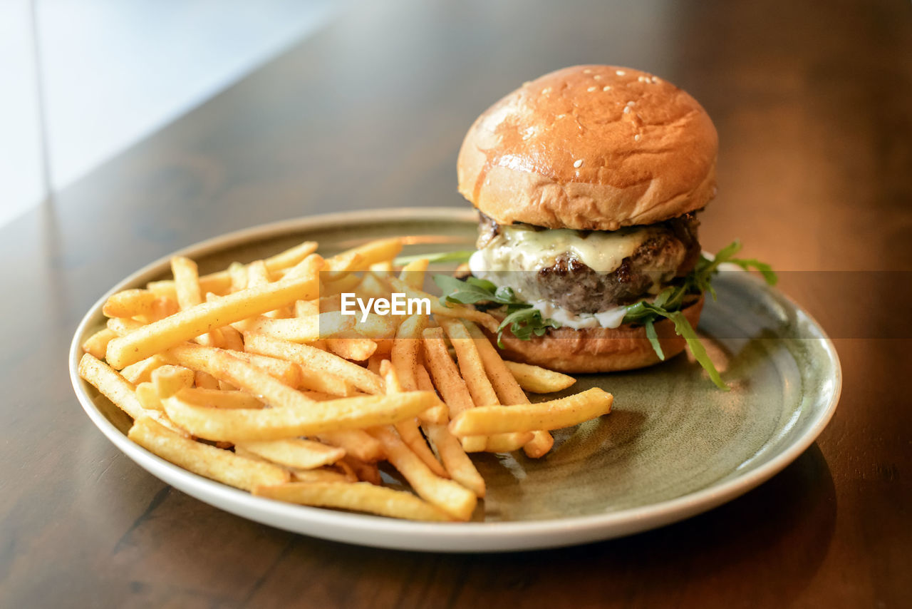 Close-up of burger and fries on table