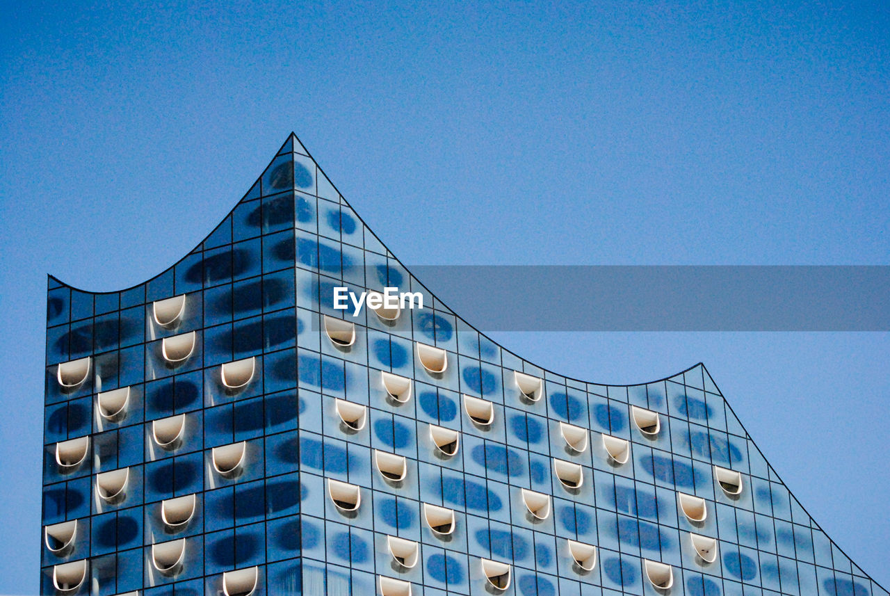 LOW ANGLE VIEW OF MODERN BUILDINGS AGAINST CLEAR BLUE SKY