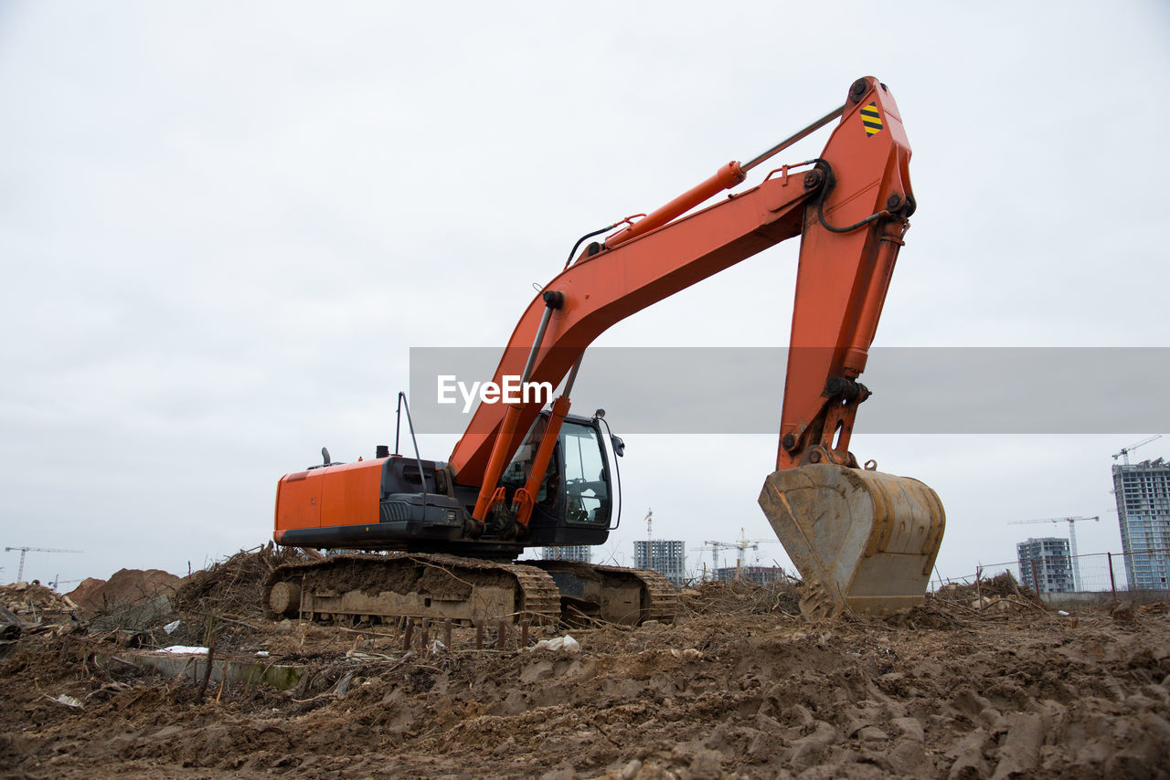 Excavator working at construction site on earthworks. backhoe digs ground for the foundation 