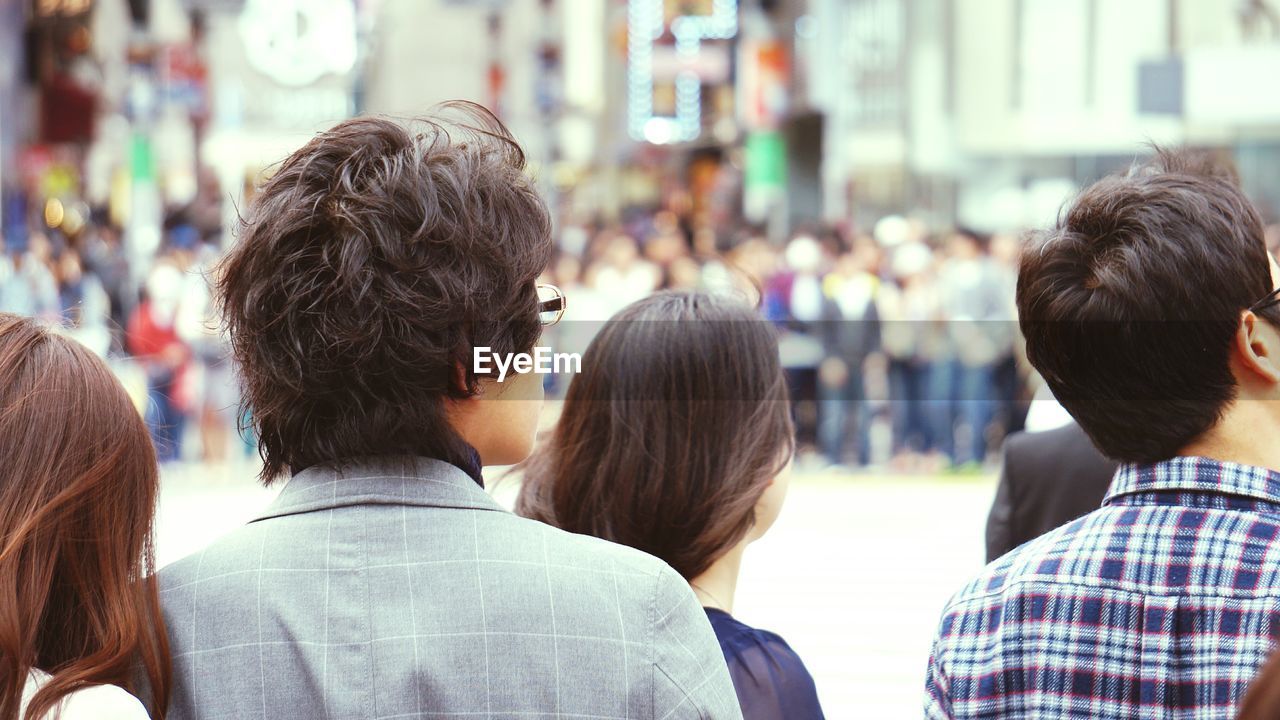 Rear view of people on city street