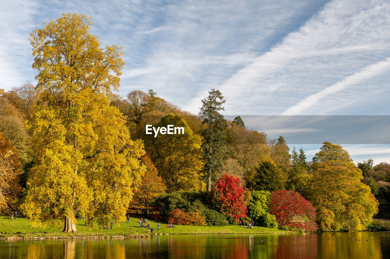 View of the autumn colours around the lake at stourhead gardens in wiltshire.