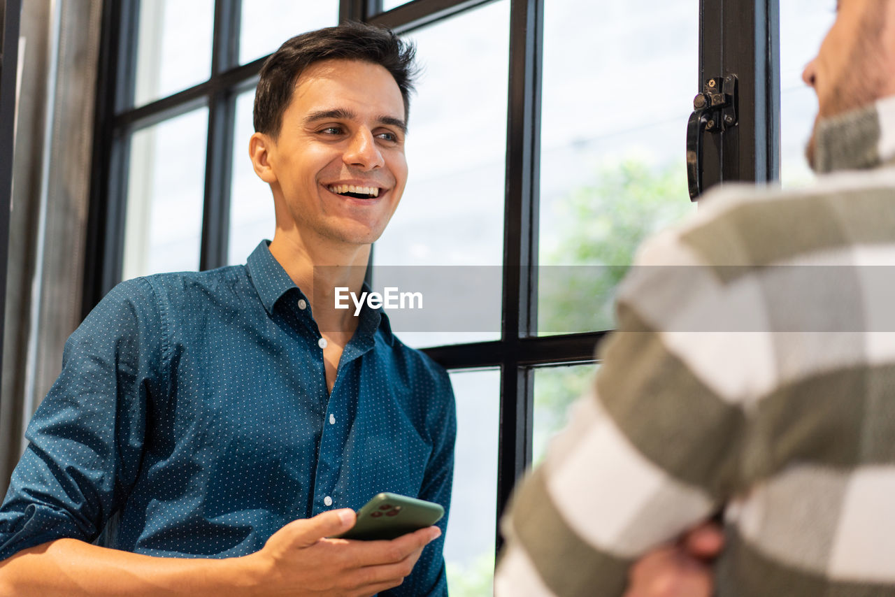 Man talking with colleague in office