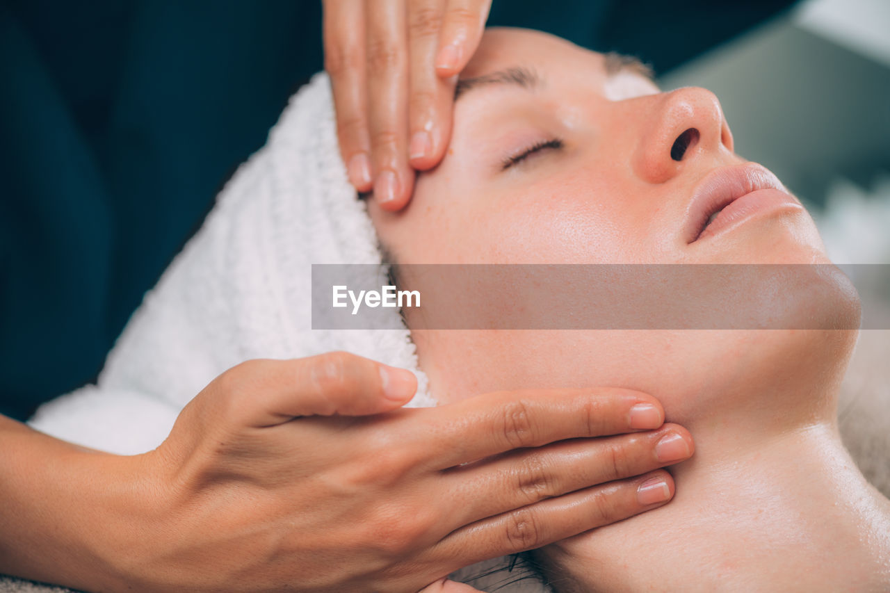 Close-up of woman getting massage therapy at spa