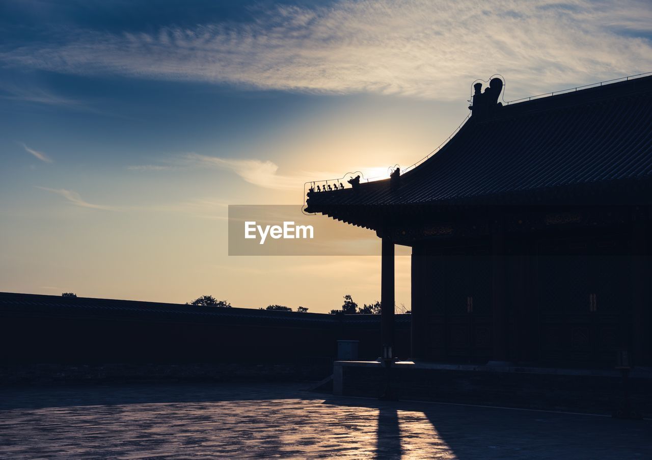 SILHOUETTE BUILDING AGAINST SKY DURING SUNSET