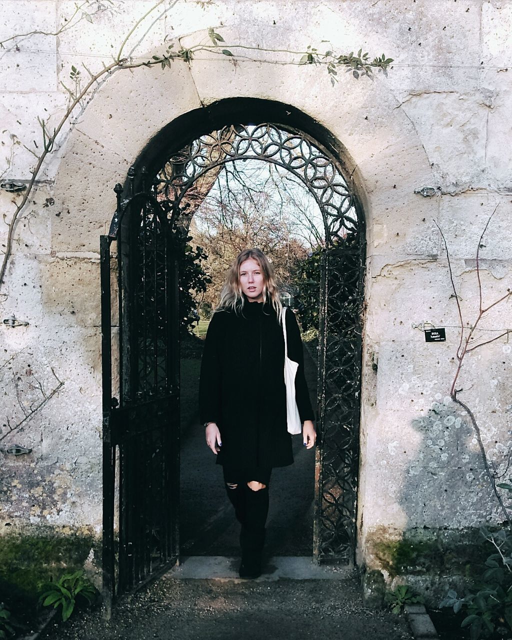 Full length of woman standing at archway