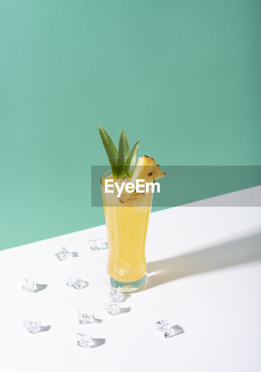 CLOSE-UP OF DRINK ON TABLE AGAINST GLASS